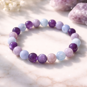 The Peacekeeper Amethyst and Lepidolite bracelet on a white marble background